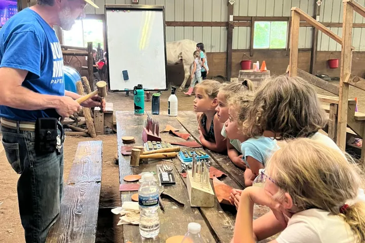 a group of people preparing food inside of a building