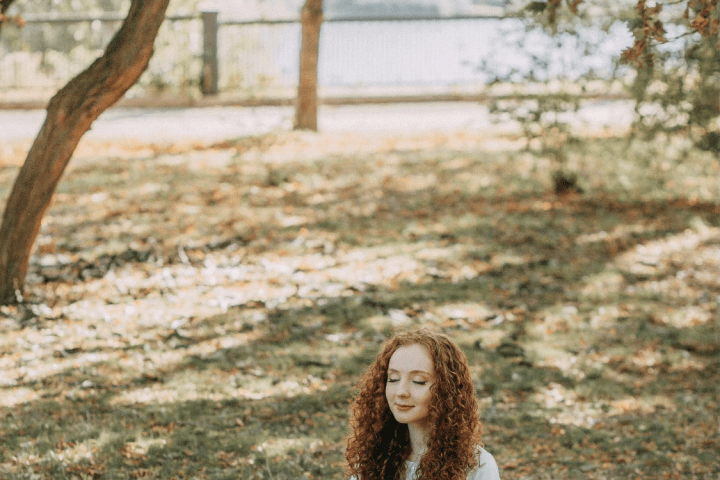 a little girl sitting on a bench
